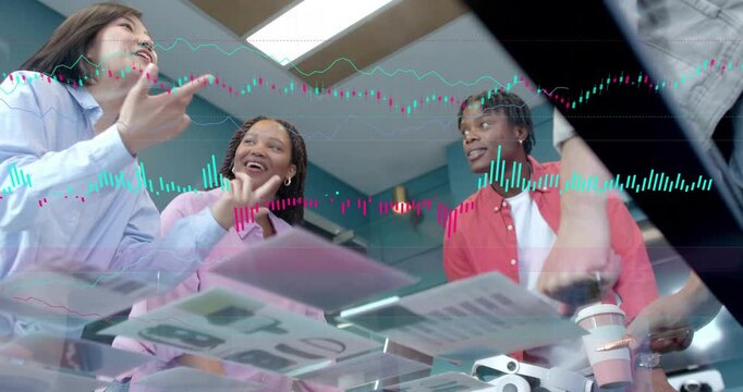 Team leaning under glass checking design mocks as PM reaching sparking chart overlay high-fiving
