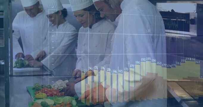 Vertical video: Chopping chefs wearing white hats prepping veg with knives in kitchen, chart rising