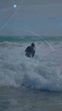 Vertical video: Surfer entering breaking surf bracing with board to reach deep water purple overlay