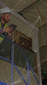 Vertical video: Site inspector on blue scaffold tapping tablet, logging data, viewing overlay lines