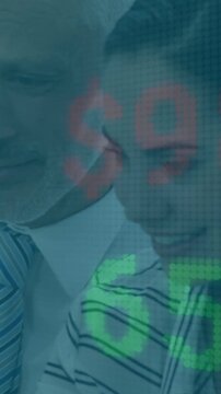 Vertical video: Mgr guiding junior monitoring finance display as green digits rising causing smiles