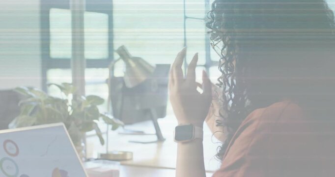 Woman picking printed chart, comparing with laptop as animated charts highlighting business trends