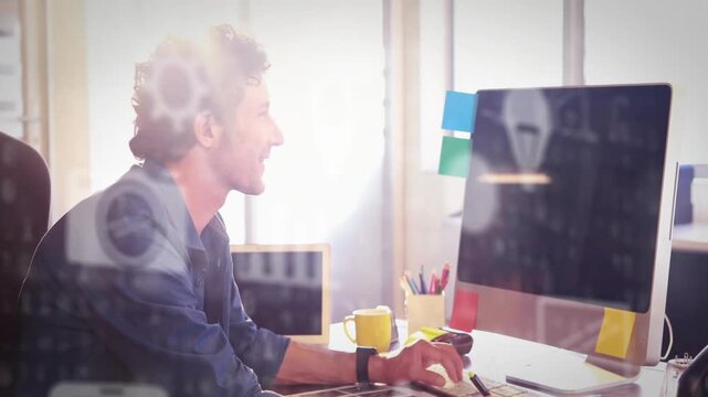 Vertical video: Noticing monitor, designer with rolled sleeves reaching tablet at desk refining art