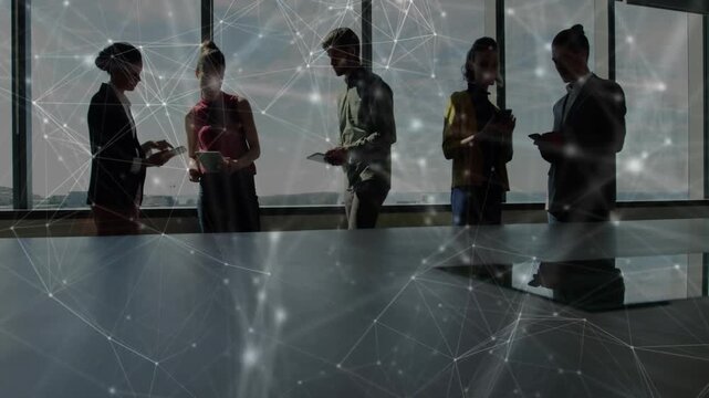 Left pair exchanging papers, office team comparing notes on tablets, network overlaying table