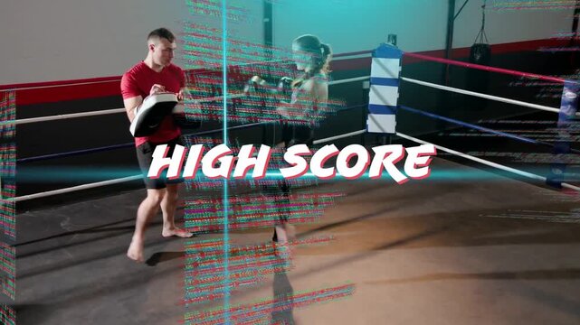 Vertical video: Training coach raising pads guiding boxer in crop top, gloves in ring, HIGH SCORE
