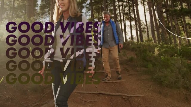 Vertical video: Walking couple down root trail on hike as GOOD VIBES text appearing, blue vest