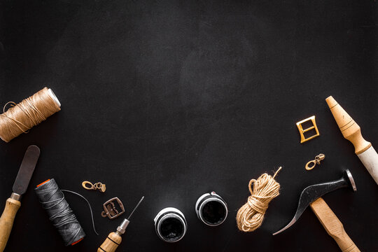 Leather craft or shoemaker tools flat lay. The workplace in a leather workshop