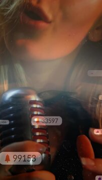 Vertical video: Music singer leaning into mic, singing and generating bubbles, seeking likes