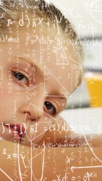 Vertical video: Cam dolly initiating close-up student leaning on desk math overlay showing thinking