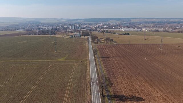 Aerial view of road heading into Svitavy through fields.
Sunny landscape with wide panorama and rural scenery.