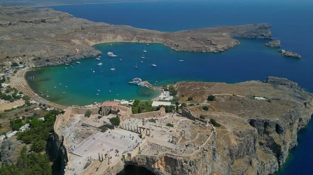 LINDOS, RHODES, GREECE - JULY 01, 2025: Aerial view of the ancient Acropolis of Lindos and the white traditional village.