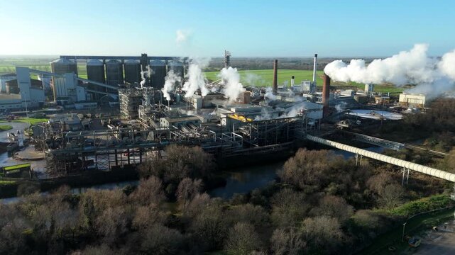 High angle drone perspective of Europe largest sugar beet processing plant in Wissington England with massive industrial silos and infrastructure.