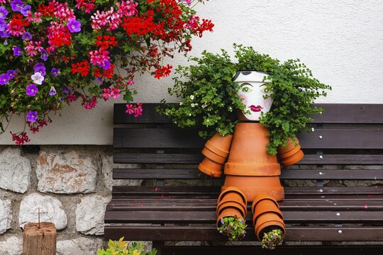 Bench and flowers, males from flower pots, Hallstatt, Salzkammergut, Upper Austria, Austria