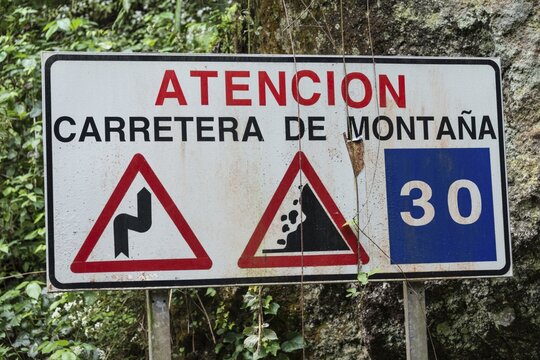 Spanish warning sign of dangers in the mountains, Barranco del Agua canyon, Laurel Forest of Los Tilos, La Palma, Canary Islands, Spain