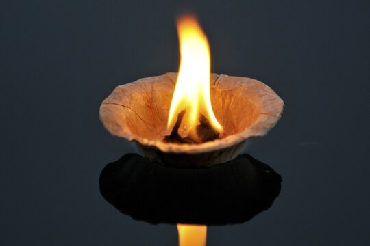 Leaf bowl with a burning wick dipped in oil, adrift on the River Narmada, Ahilya, Madhya Pradesh, North India, Asia
