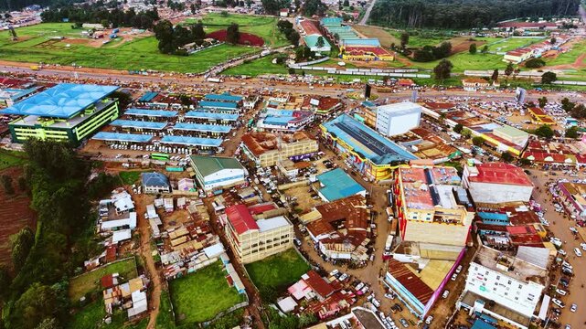 Aerial flyover poor Kitale Slum and modern skyline of Kitale rural urban area of kenya during sunny day. Two class society in Africa.