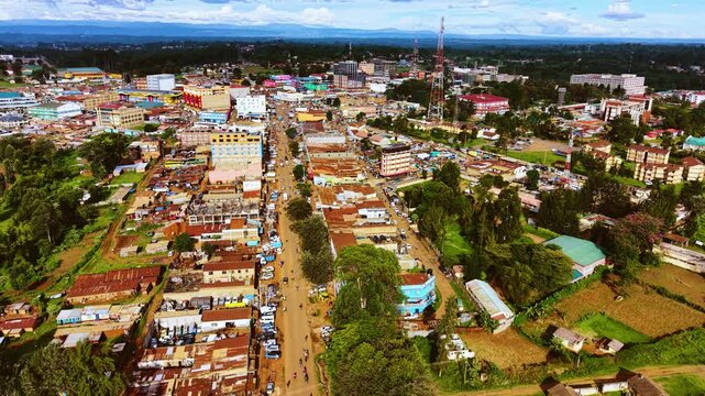 Aerial flyover poor Kitale Slum and modern skyline of Kitale rural urban area of kenya during sunny day. Two class society in Africa.