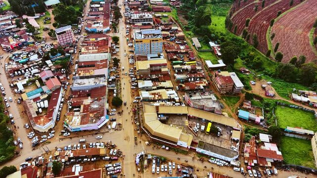 Aerial flyover poor Kitale Slum and modern skyline of Kitale rural urban area of kenya during sunny day. Two class society in Africa.