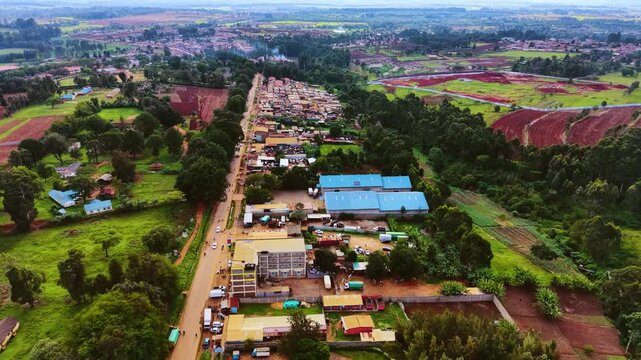 Aerial flyover poor Kitale Slum and modern skyline of Kitale rural urban area of kenya during sunny day. Two class society in Africa.