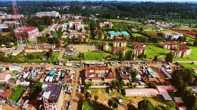 Aerial flyover poor Kitale Slum and modern skyline of Kitale rural urban area of kenya during sunny day. Two class society in Africa.