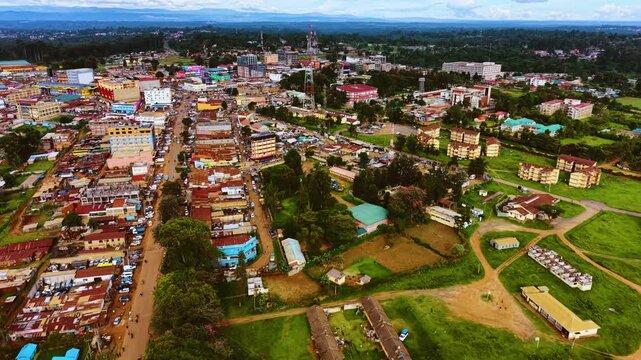 Aerial flyover poor Kitale Slum and modern skyline of Kitale rural urban area of kenya during sunny day. Two class society in Africa.