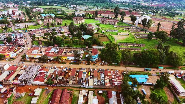 Aerial flyover poor Kitale Slum and modern skyline of Kitale rural urban area of kenya during sunny day. Two class society in Africa.