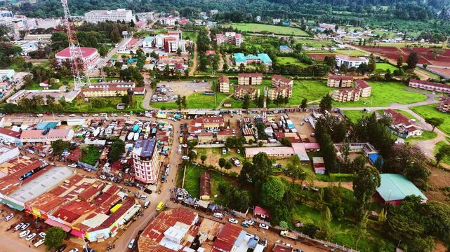Aerial flyover poor Kitale Slum and modern skyline of Kitale rural urban area of kenya during sunny day. Two class society in Africa.