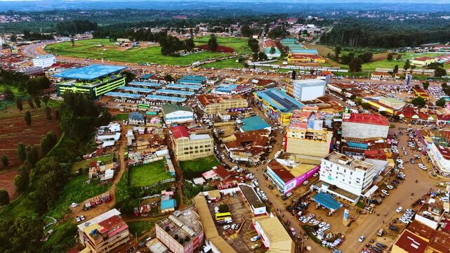Aerial flyover poor Kitale Slum and modern skyline of Kitale rural urban area of kenya during sunny day. Two class society in Africa.