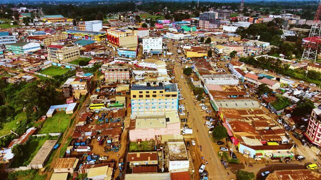 Aerial flyover poor Kitale Slum and modern skyline of Kitale rural urban area of kenya during sunny day. Two class society in Africa.