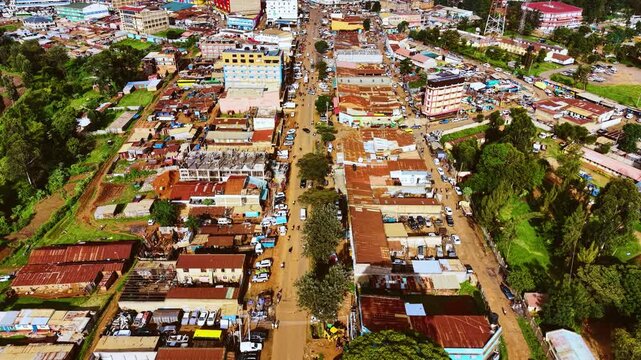 Aerial flyover poor Kitale Slum and modern skyline of Kitale rural urban area of kenya during sunny day. Two class society in Africa.