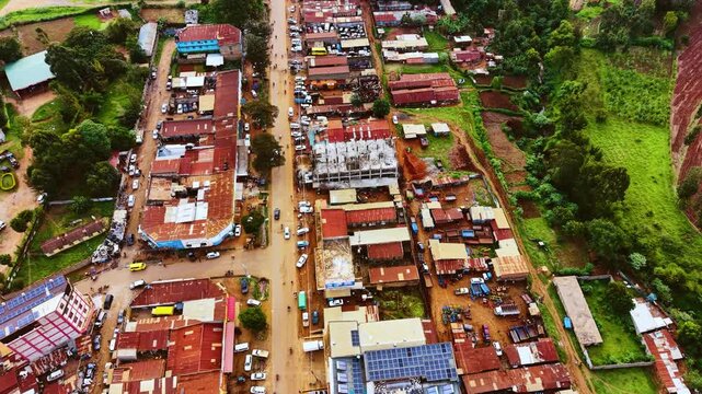 Aerial flyover poor Kitale Slum and modern skyline of Kitale rural urban area of kenya during sunny day. Two class society in Africa.