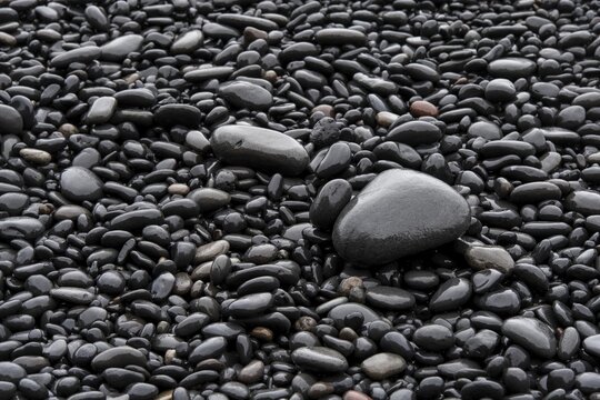Black wet stones at Reynisfjara lava beach, near V&iacute;k &iacute; M&yacute;rdal, south coast, Iceland