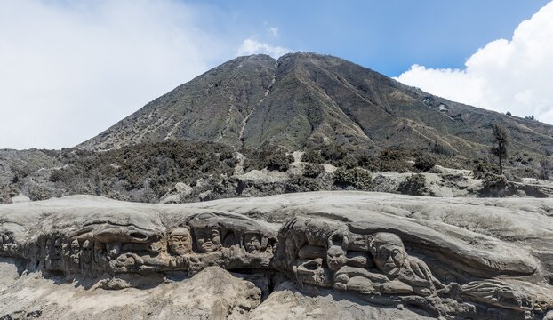 Faces carved into rock, Mount Batok, Bromo Tengger Semeru National Park, East Java, Indonesia