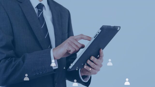 Male professional tapping tablet in business causing animated avatars shifting to contact clusters
