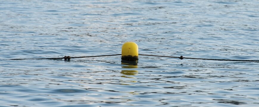 Yellow buoy, on ropes, Sestri Levante, Liguria, Italy