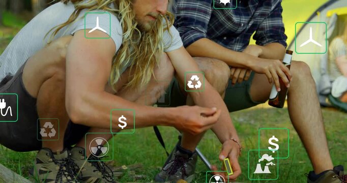 Two men at fire pit, left man taking lighter, sparking tinder for warmth, energy icons overlaying