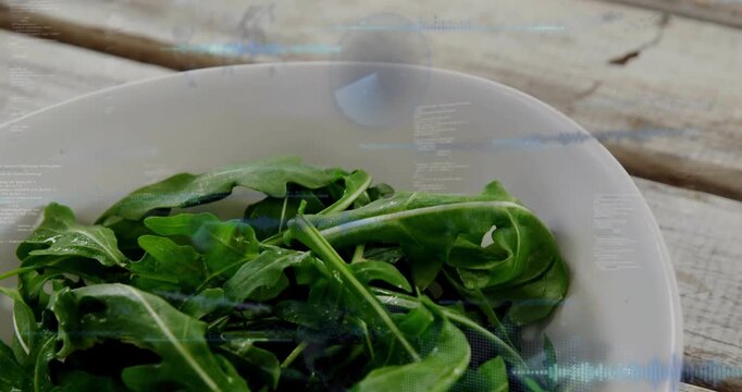 Vertical video: Camera moving down showing greens bowl on wood table, blue HUD rising for food tech