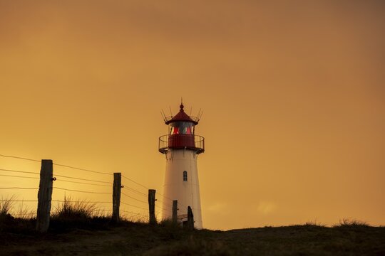 List-ost lighthouse, in dune landscape at golden hour, Ellenbogen, List, Sylt Island, Germany