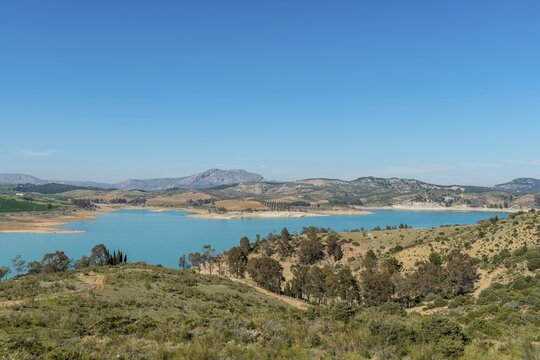 Embalse del Conde de Guadalhorce reservoir, turquoise lake in a dry landscape, dammed up River Guadalhorce, Andalusia, Spain