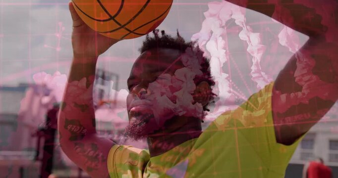 Male player raising basketball from chest to hoop, pink overlays layering over him aiming to shoot