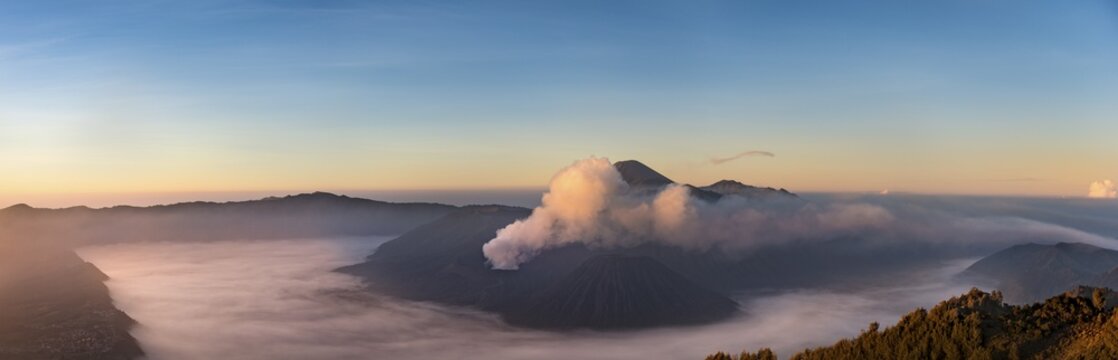 Caldera Tengger, view of volcanoes at sunrise, smoking volcano Gunung Bromo, with Mt. Batok, Mt. Kursi, Mt. Gunung Semeru, National Park Bromo-Tengger-Semeru, Java, Indonesia