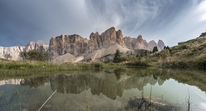 Sella Group with Piscadu reflected in a pond, Gardena Pass, Passo Gardena, nature park Park Puez Iceman, Dolomites, Selva di Val Gardena, South Tyrol, Trentino-Alto Adige, Italy