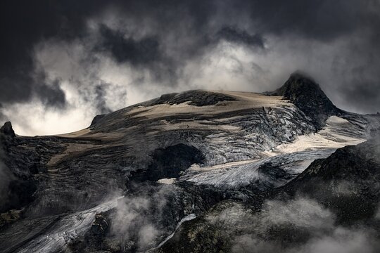Bernina Group with Rosegg Glacier and dramatic clouds at blue hour, St Moritz, Engadin, Grisons, Switzerland