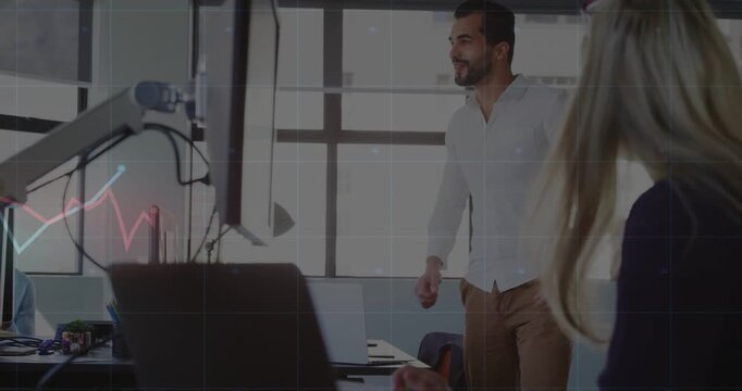 Man straightening and fist-pumping as animated business graphs appearing on screen showing success