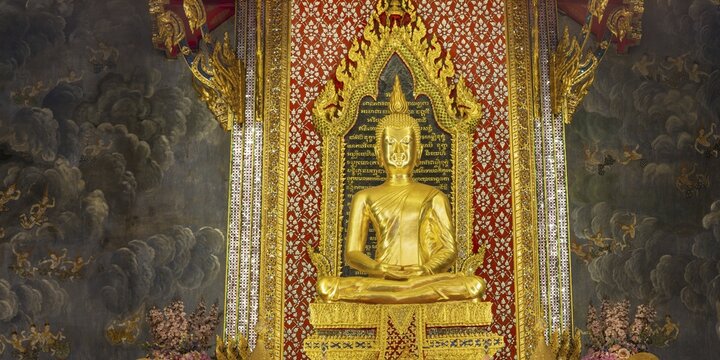 Golden meditating Buddha surrounded by wall paintings with Buddhist teachings and representations of Buddha's disciples, Wat Makut Kasatriyaram Ratchaworavihan, Phra Nakhon District, Old Bangkok, Thailand
