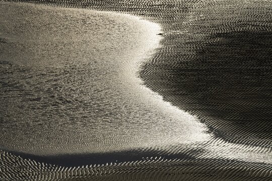 Water edge with ripples on a beach at low tide, Patreksfj&ouml;r&eth;ur, Westfjords, Iceland
