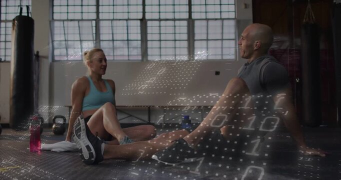 Gym partners sitting on floor catching breath postset overlay with binary high-fiving under digits