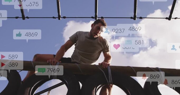 Male athlete gripping beam, sliding across tire stack in fitness as heart icons appearing overhead