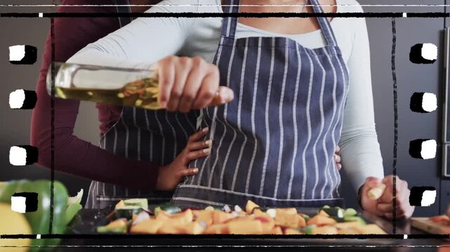 Lead woman tipping oil bottle, pouring oil dressing tray, rear partner guiding, cooking overlay