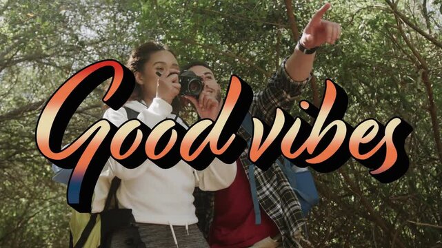 Vertical video: Woman raising camera when man pointing and guiding while hiking, Good Vibes overlay